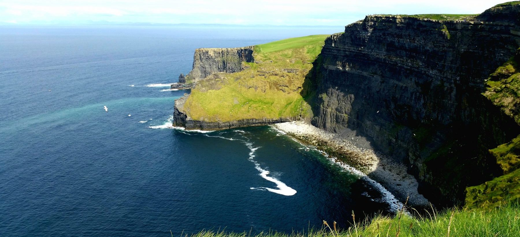 Wind slowly moving the waves to the Cliffs of Moher, Co. Clare in Ireland